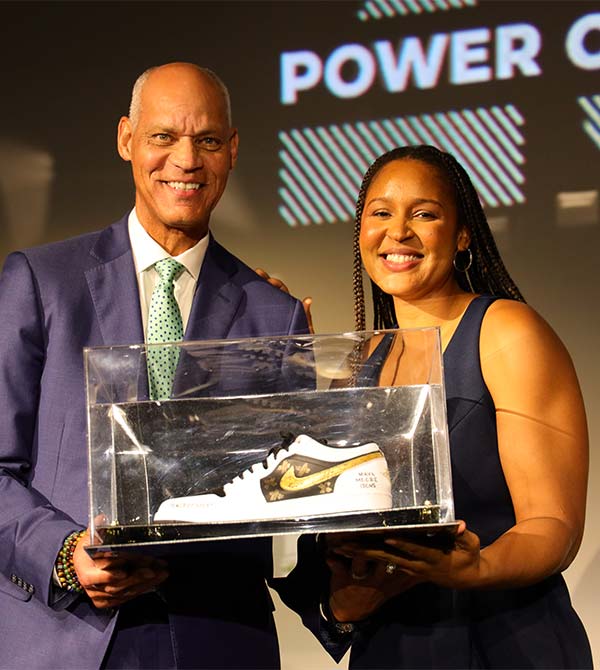 Kareem Abdul-Jabbar and a gala honoree pose with a commemorative sneaker award