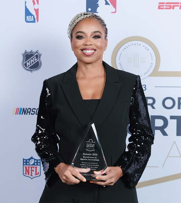 Jemele Hill holds her Excellence in Sports Journalism award at the Power of Sport Gala